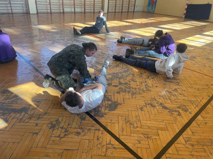 Uczniowie wykonują ćwiczenia podczas szkolenia z żołnierzami WOT